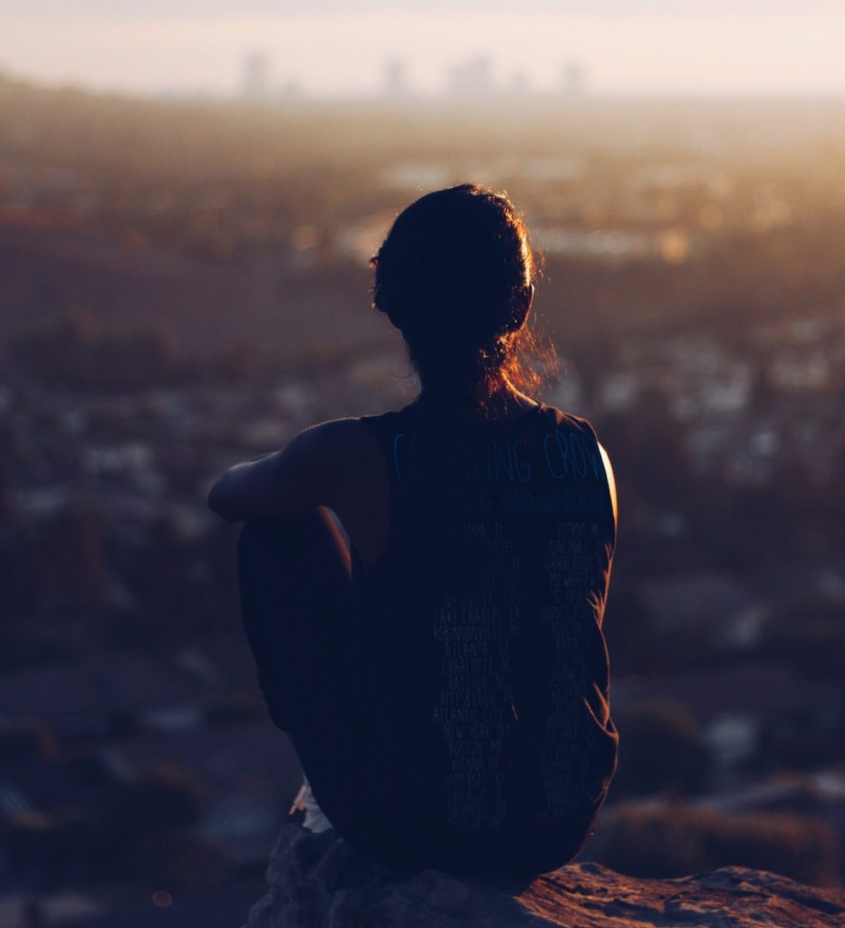 Girl looking out over hazy city