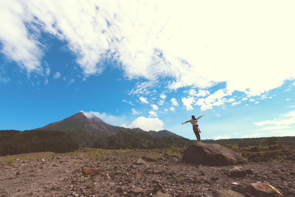 Woman Standing with Arms Outstretched in Nature.