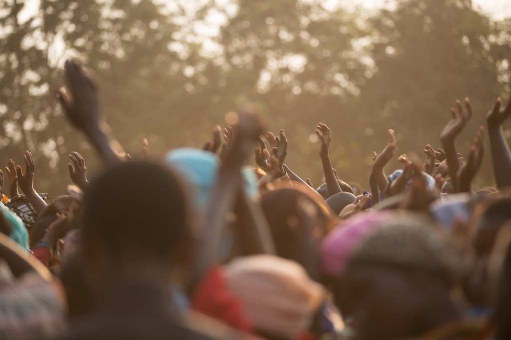 Crowd with arms raised.