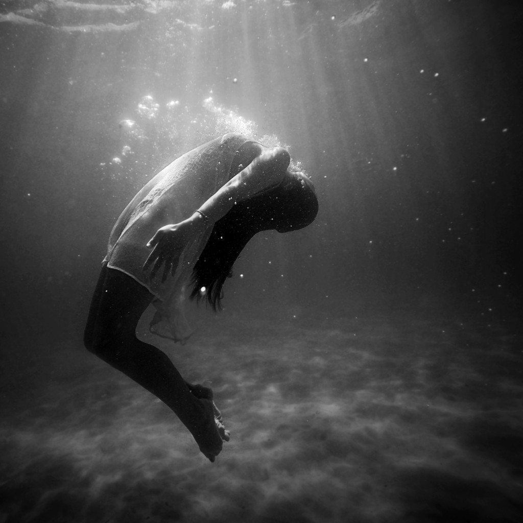 Ephemeral woman in water and sunlight