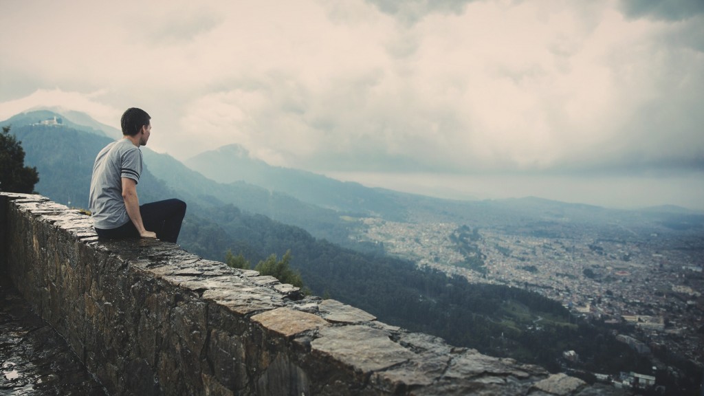 Man Looking Out Over City and Forest