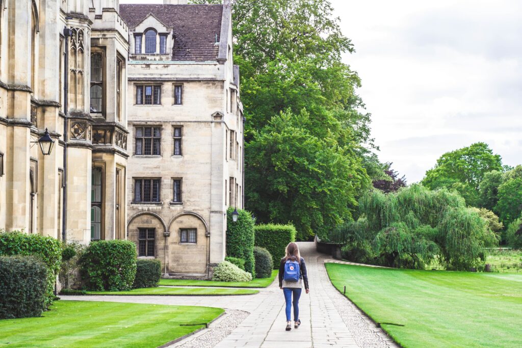 Woman walking on a path next to a university building