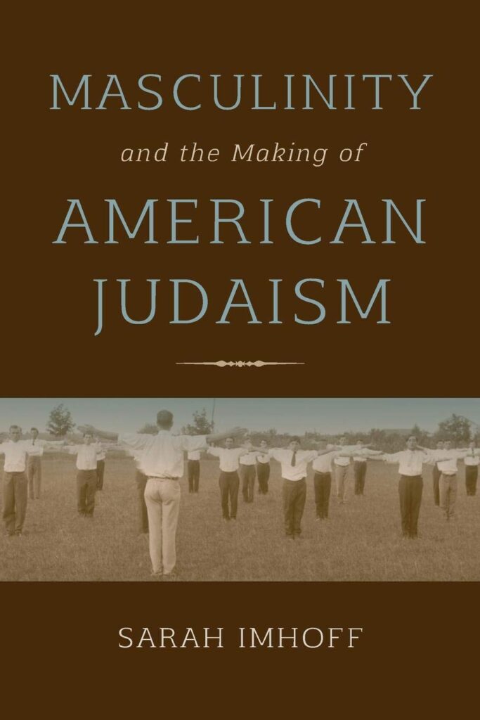 A brown book with the title in light blue, and an image of men in a field with their arms out